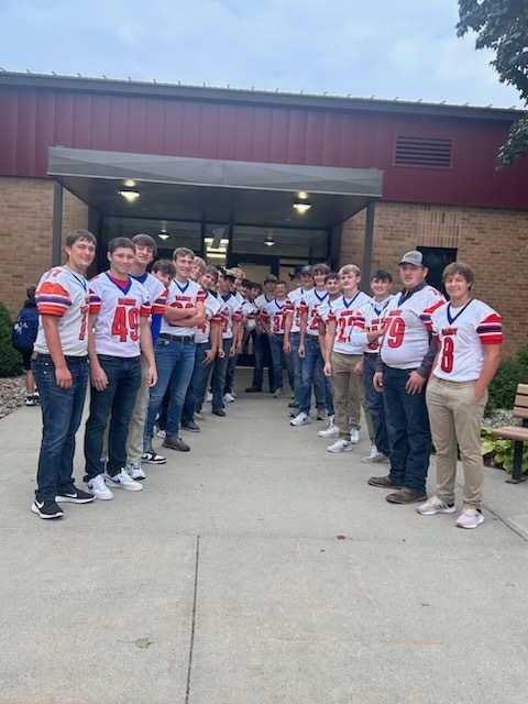 Canby Lancer football team greeting students at the elementary school front door.